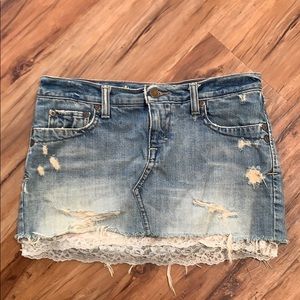 Distressed denim miniskirt with lace detail